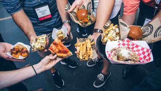 Several people showing different types of food